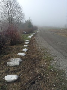 Sandbags lie at the ready beside the driveway before the tarp was laid down.