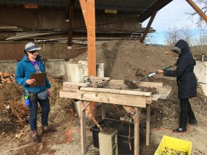 A student uses the compost sifter