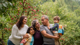 happy family hugging in the woods