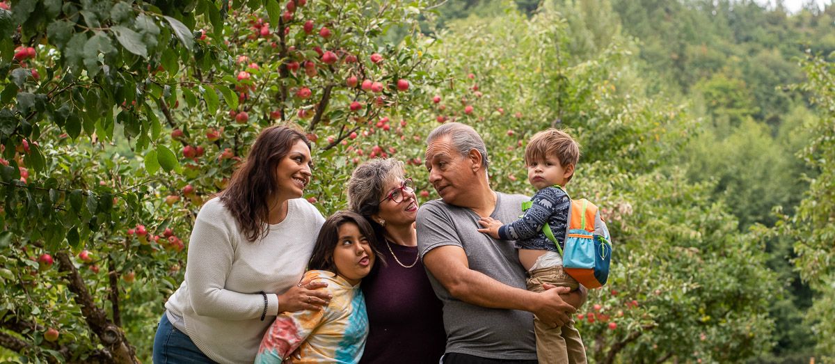 happy family hugging in the woods