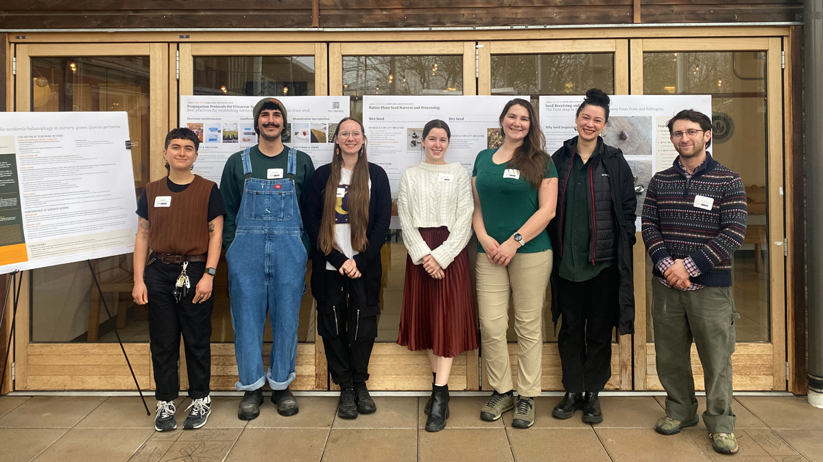 Oxbow Native Plant Nursery team standing with research posters at the Washington Botanical Symposium.
