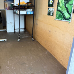 Mud line on office wall showing floodwater height inside building