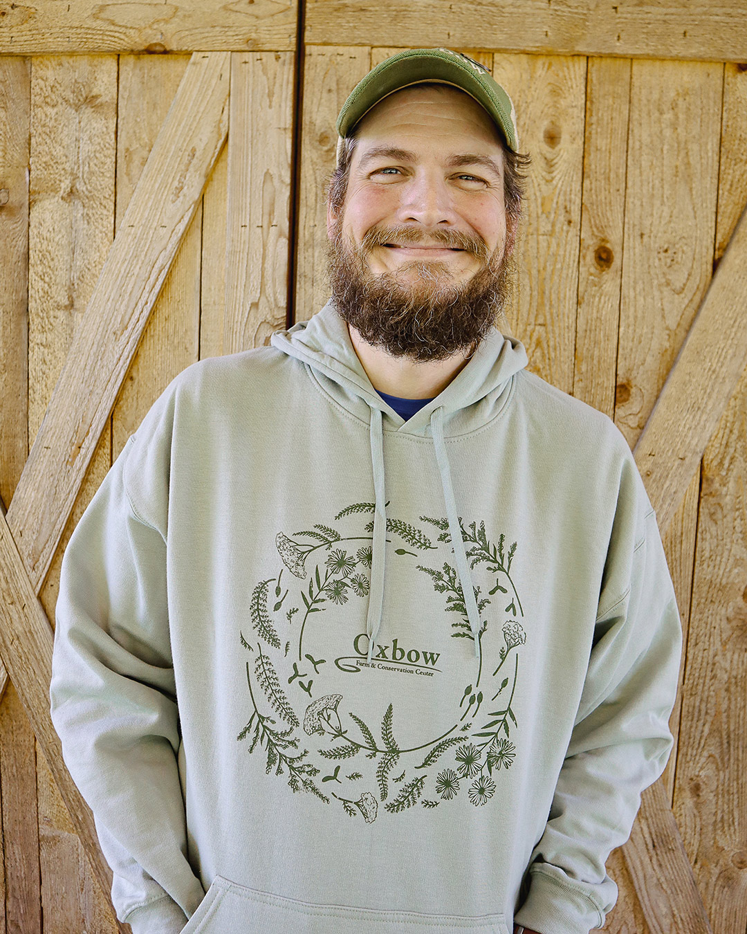 Tony wearing Oxbow native flora hoodie featuring Pacific Northwest native plant illustrations.